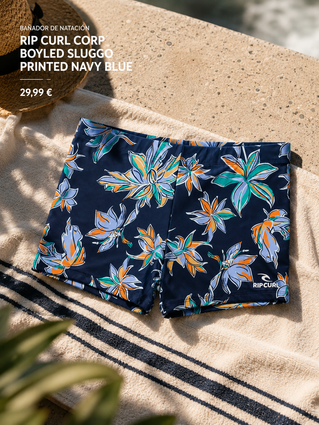 Bañador de natación Rip Curl Corp Boyleg Sluggo Printed Navy Blue sobre toalla de playa en escena surf cinema aesthetic premium