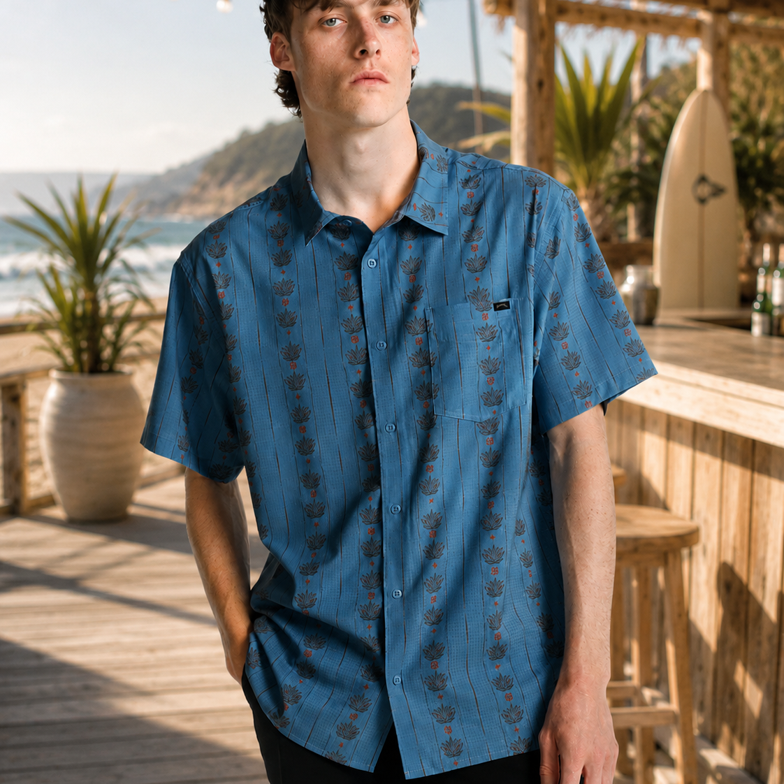 Camisa Billabong Surftrek Perf Mid Blue para hombre en paseo marítimo junto a la playa con estilo surf lifestyle y ambiente Costa del Sol