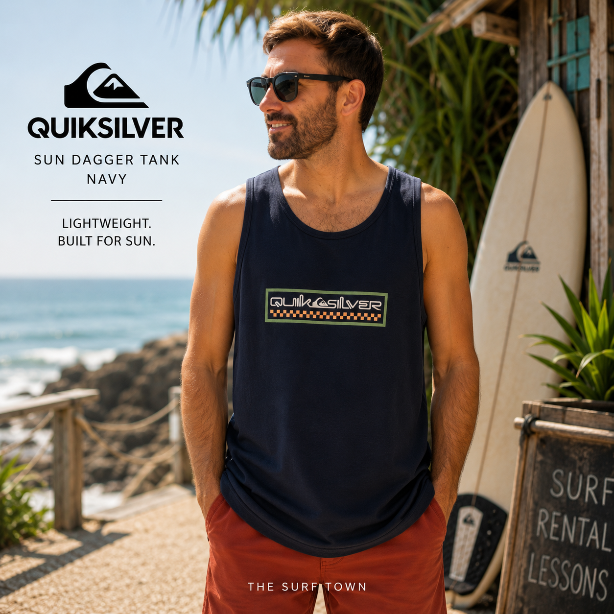 Camiseta Quiksilver Sun Dagger Tank Navy para hombre en entorno surf tropical, fotografía editorial propia de THE SURF TOWN, camiseta de tirantes azul marino con logo frontal Quiksilver para verano y surf lifestyle.