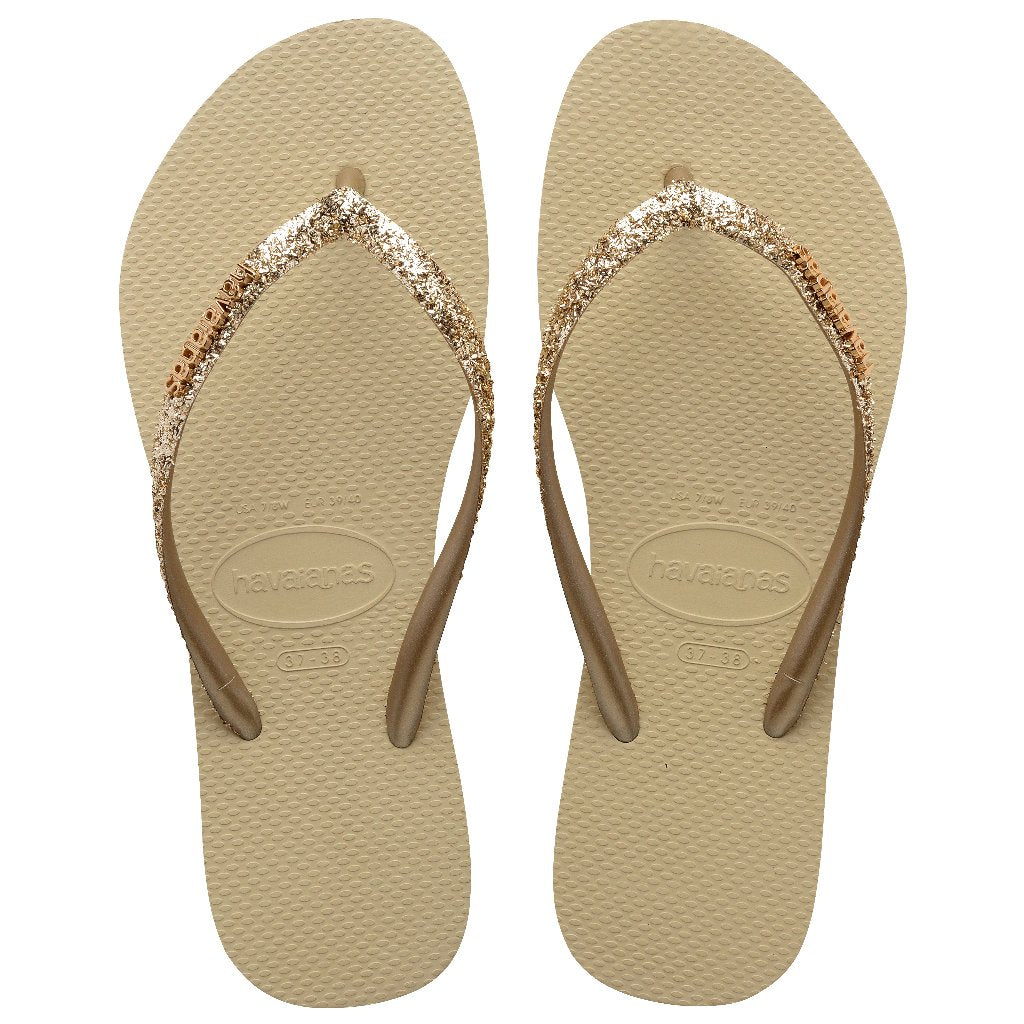 Chanclas Havaianas Slim Glitter II Beige Gold mujer con tiras finas glitter doradas y suela cómoda de goma ideales para verano, playa y piscina