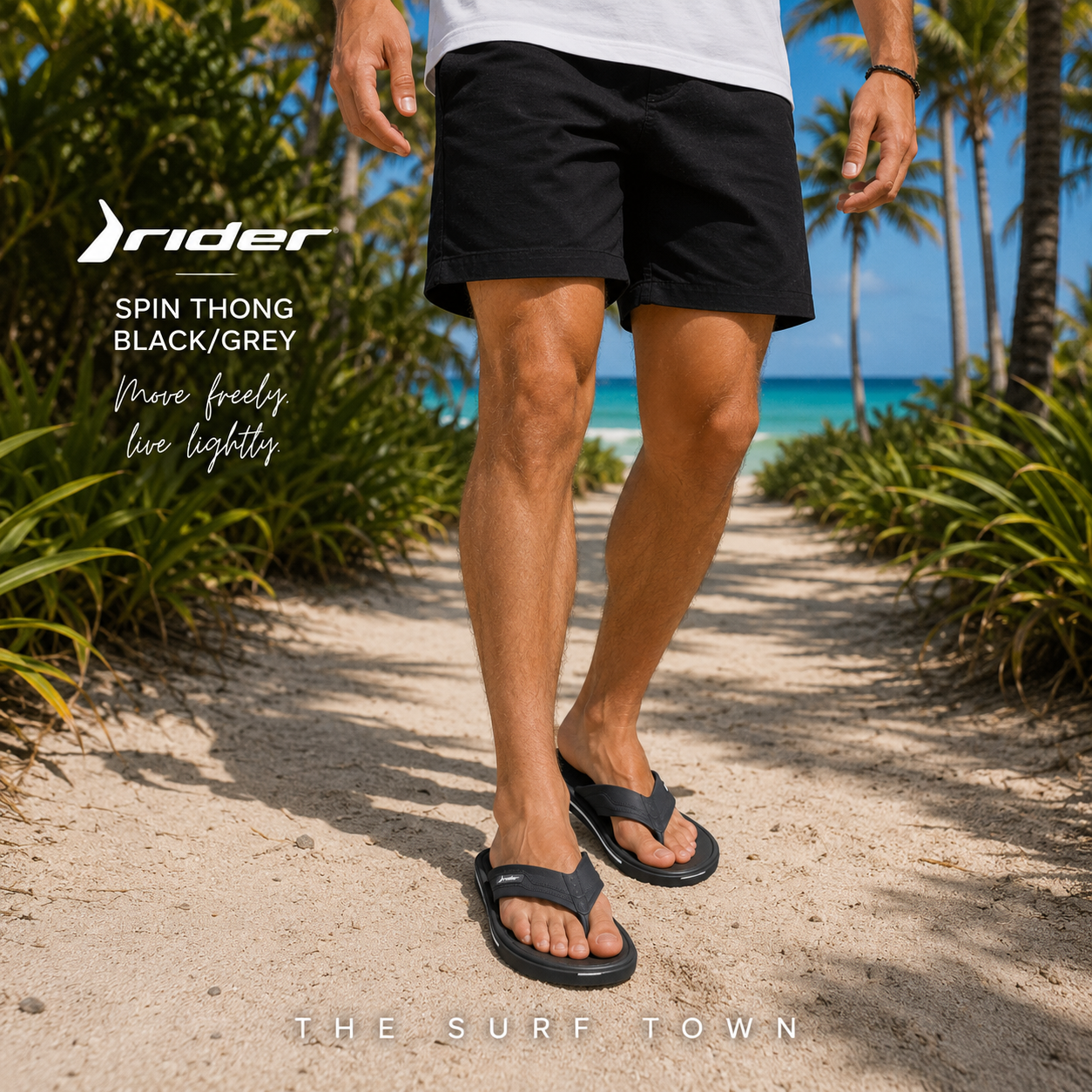 Chanclas Rider Spin Thong Black Grey en fotografía editorial propia de THE SURF TOWN en camino de arena blanca entre palmeras con estilo beach lifestyle masculino