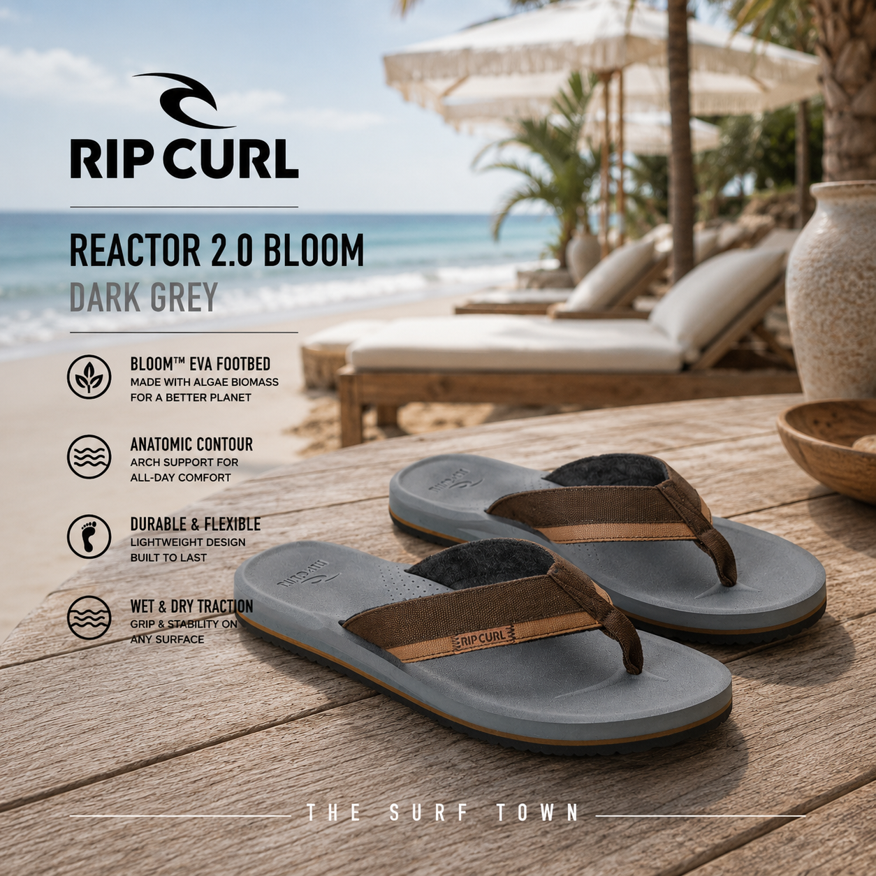 Chanclas Rip Curl Reactor 2.0 Bloom Dark Grey en fotografía editorial propia de THE SURF TOWN en beach club premium frente al mar con plantilla Bloom EVA, gran comodidad, diseño ligero y estilo surf para verano.