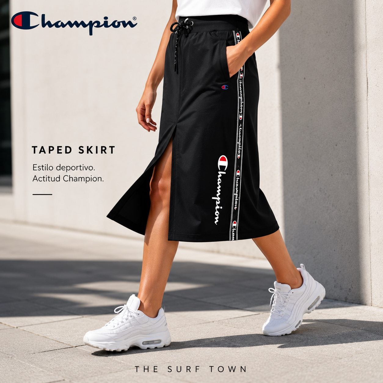 Falda Champion Taped Skirt negra para mujer en fotografía editorial propia de THE SURF TOWN con estilo urbano deportivo y estética lifestyle premium