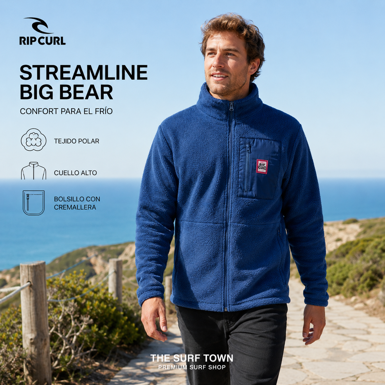 Hombre con forro polar Rip Curl Streamline Big Bear azul en un sendero costero, imagen editorial propia de THE SURF TOWN