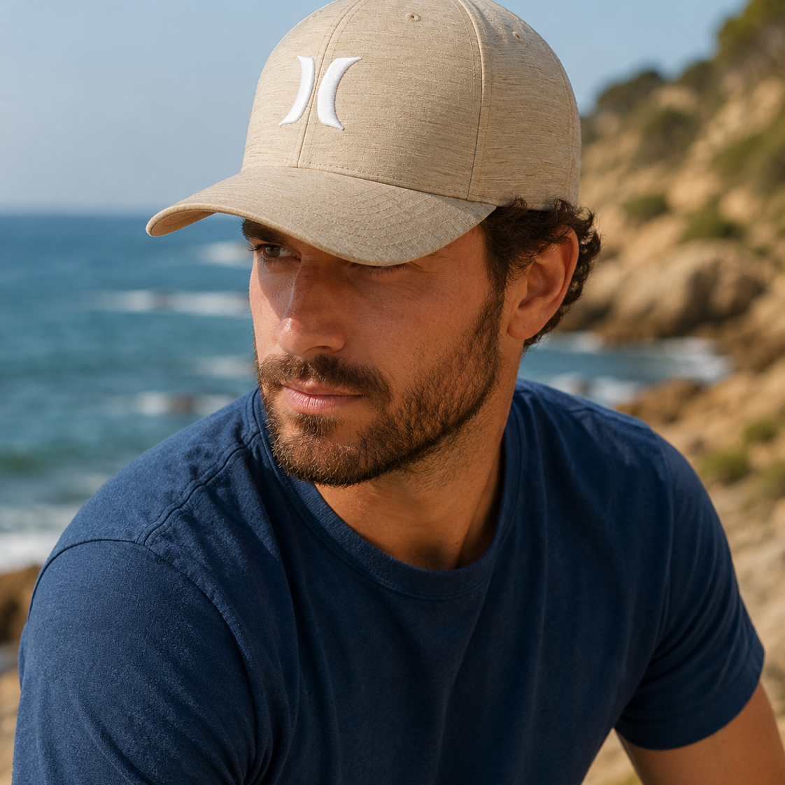 Gorra Hurley beige H2O Dri estilo surf lifestyle en entorno de costa mediterránea para hombre