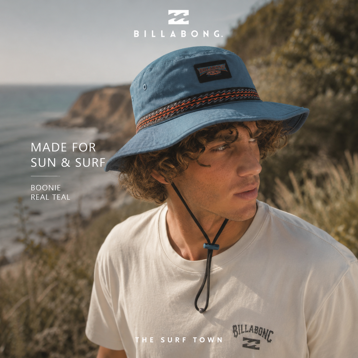 Gorro Billabong Boonie Real Teal en acantilados costeros junto al mar, fotografía editorial propia de THE SURF TOWN inspirada en el surf lifestyle, la aventura y la protección solar al aire libre