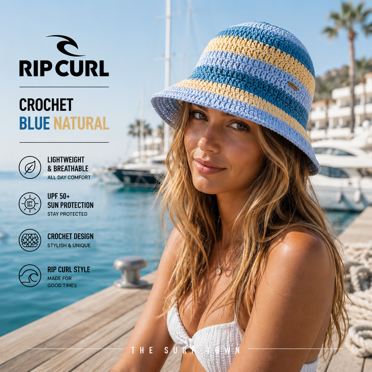 Gorro Rip Curl Crochet Blue Natural en fotografía editorial propia de THE SURF TOWN con modelo en marina mediterránea premium, diseño crochet de inspiración surf, protección solar y estilo veraniego para playa, barco y vacaciones.