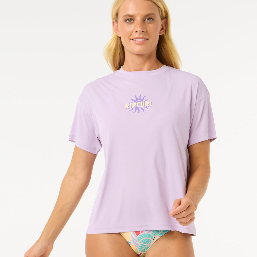 Licra RIP CURL Cala Vadella Surflite mujer color lila protección UV50 surf manga corta