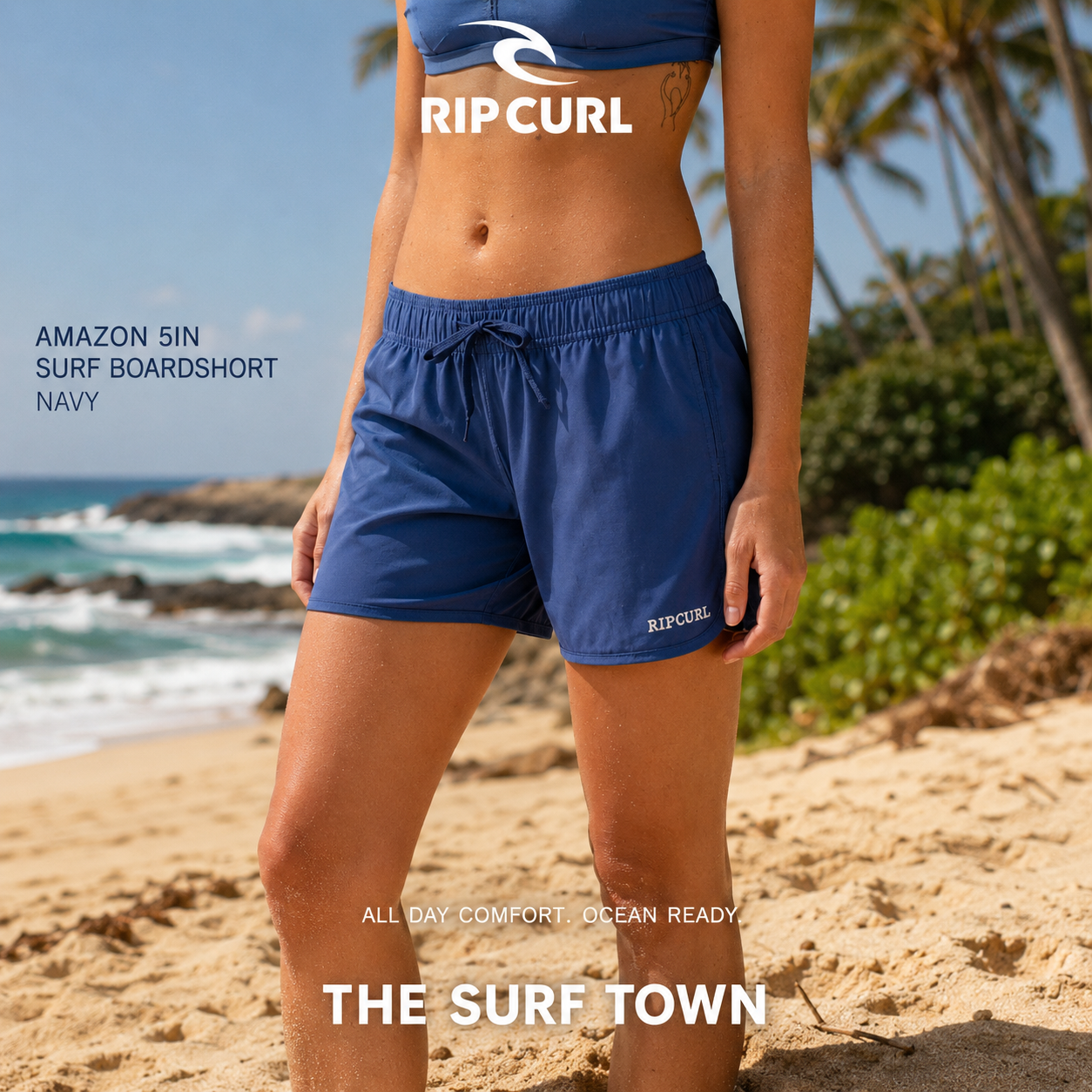 Pantalón Rip Curl Amazon 5in Surf Boardshort Navy para mujer en fotografía editorial propia de THE SURF TOWN sobre playa tropical de arena dorada y ambiente de vacaciones premium.
