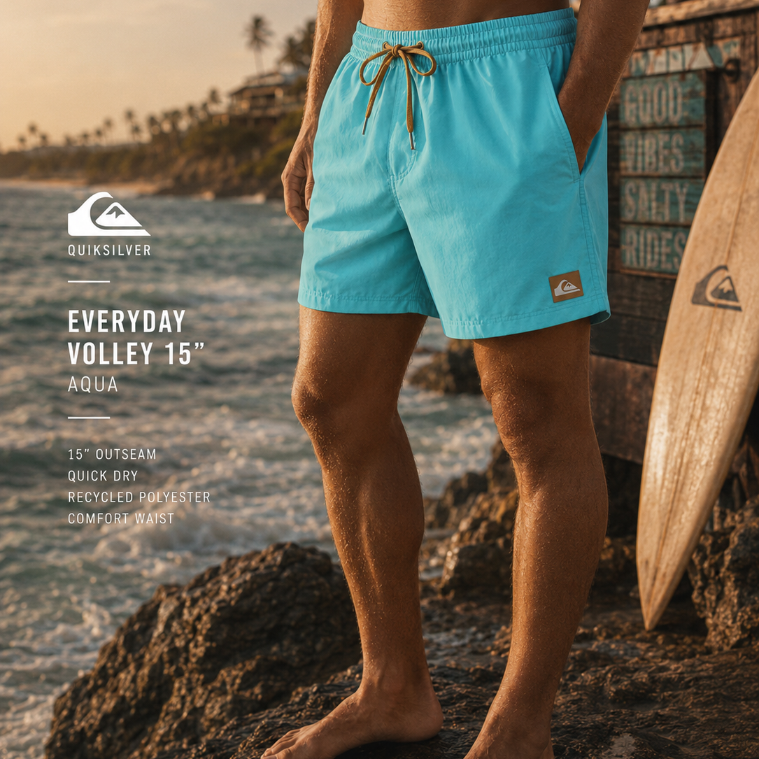 Bañador Quiksilver Everyday Solid Volley 15 Aqua para hombre en escenario surf premium con rocas, mar y luz dorada cinematográfica