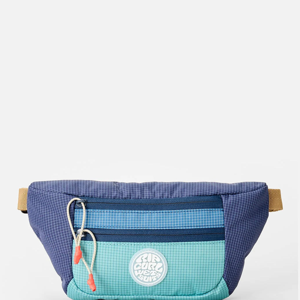 Riñonera Rip Curl Rip Waist Bag Multicolor en tonos azul y turquesa inspirados en el océano para viajes, playa y surf lifestyle