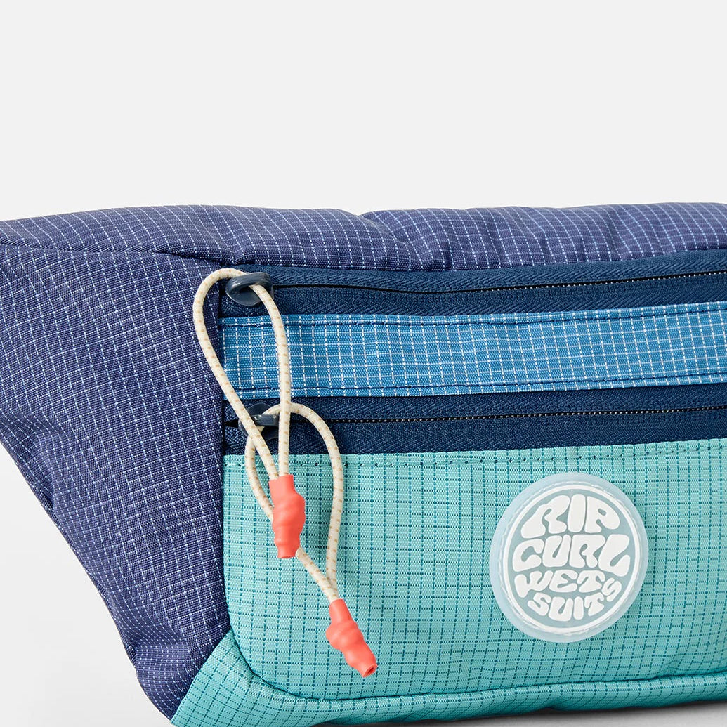 Riñonera Rip Curl Rip Waist Bag Multicolor en tonos azul y turquesa inspirados en el océano para viajes, playa y surf lifestyle