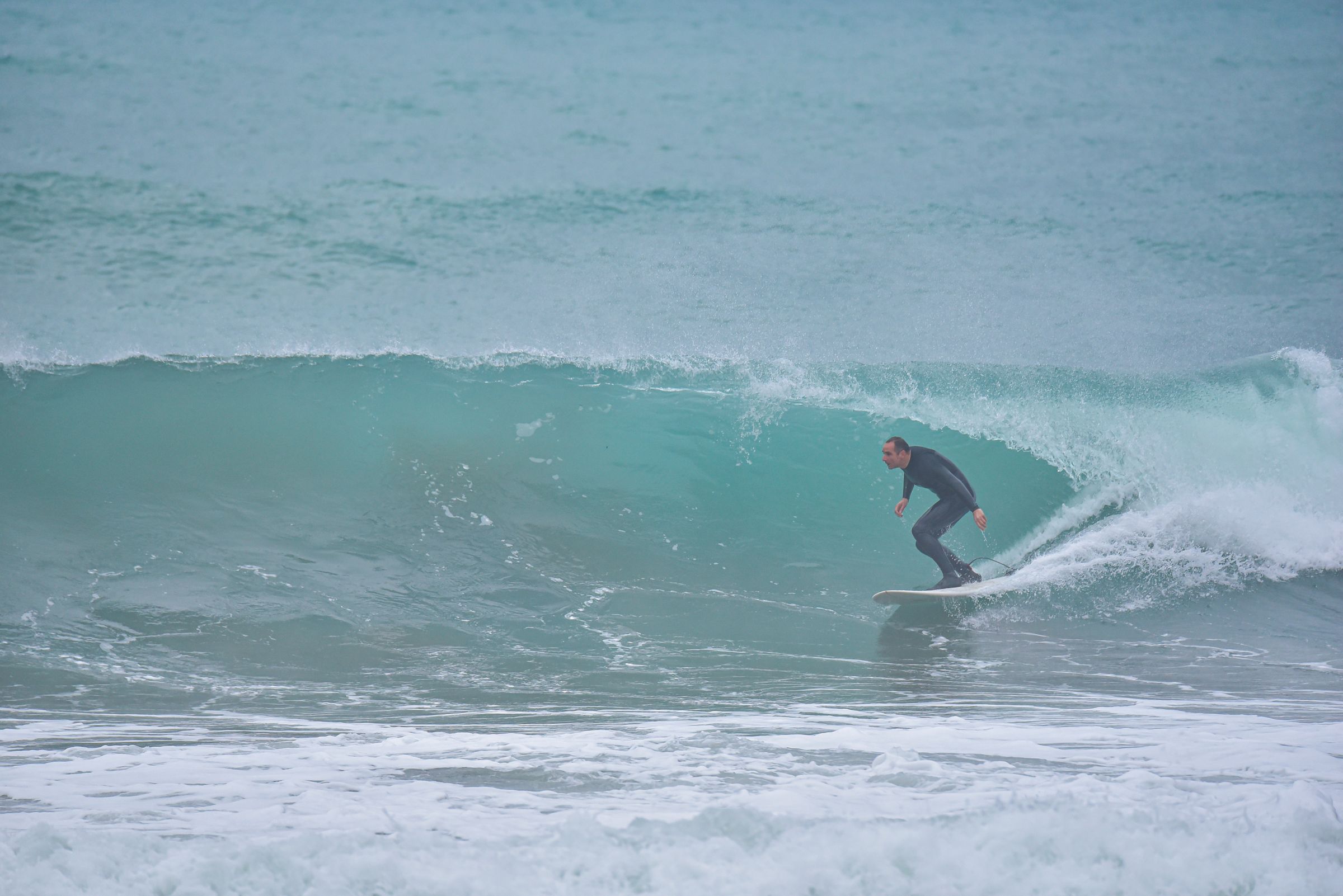 Surfista avanzando por el interior de una ola tubular