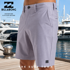 Bermudas híbridas Billabong Crossfire Mid Light Purple para hombre en marina premium mediterránea con yates de lujo, fotografía editorial propia de THE SURF TOWN inspirada en el surf lifestyle internacional
