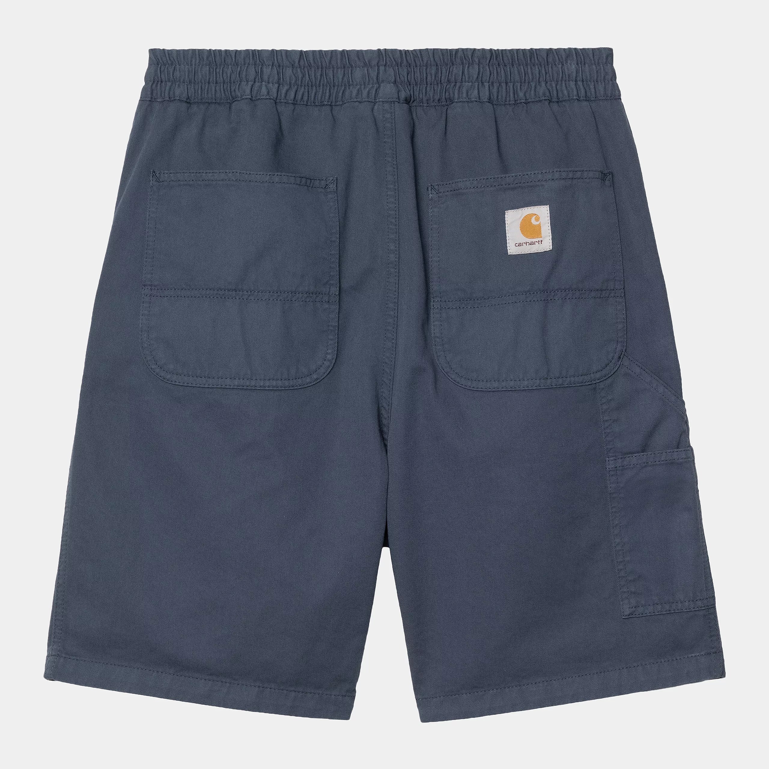 Bermudas Carhartt WIP Flint Short Dusky Blue Garment Dyed azul con cintura elástica y parche Carhartt WIP en la parte trasera