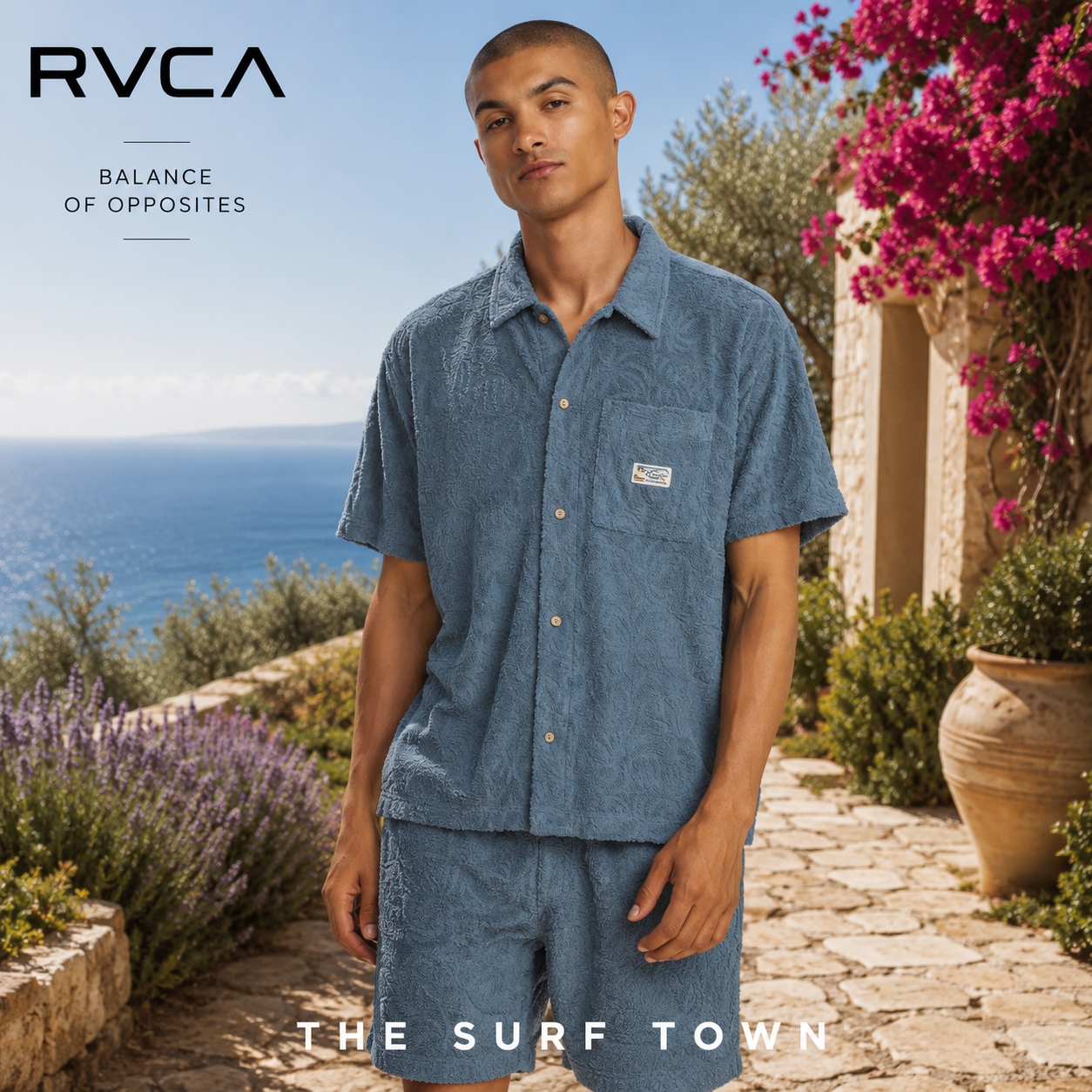 Camisa RVCA Exotica Vintage Navy para hombre en jardín mediterráneo premium frente al mar, fotografía editorial propia de THE SURF TOWN inspirada en el surf lifestyle sofisticado