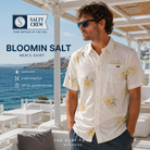 Fotografía propia de THE SURF TOWN de la camisa Salty Crew Bloomin Salt para hombre en un beach club blanco de Mykonos con vistas al mar y ambiente surf lifestyle premium.