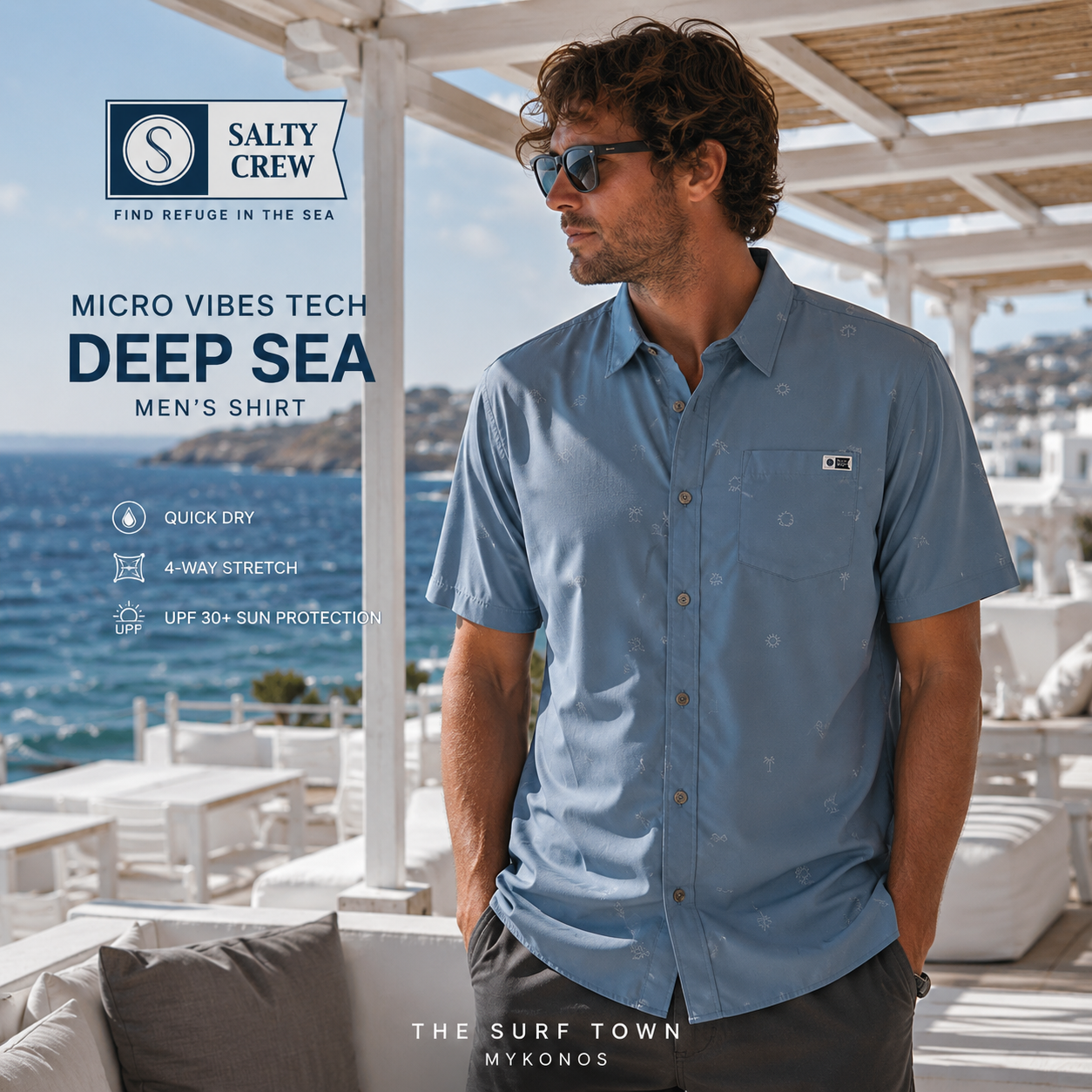 Fotografía propia de THE SURF TOWN de la camisa Salty Crew Micro Vibes Tech Deep Sea para hombre en un beach club blanco de Mykonos con vistas al mar Mediterráneo y estilo surf premium.