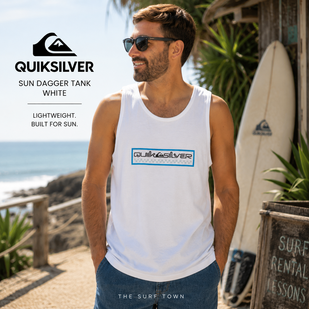Camiseta Quiksilver Sun Dagger Tank White para hombre en entorno surf tropical, fotografía editorial propia de THE SURF TOWN, camiseta de tirantes blanca con logo frontal Quiksilver para verano, playa y surf lifestyle.