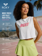 Crop top Roxy Essential Energy Coconut Milk para mujer en escena fitness surf lifestyle premium al aire libre