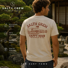 Camiseta Salty Crew Bottle Rocket Moonbeam en jardín japonés minimal premium, fotografía editorial propia de THE SURF TOWN con modelo surf lifestyle masculino, gráfico trasero Happy Hour y estilo costero relajado