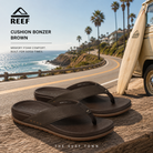 Chanclas Reef Cushion Bonzer Brown para hombre en fotografía lifestyle premium sobre carretera coastal California con estilo surf clásico y confort diario