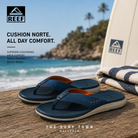 Chanclas Reef Cushion Norte Deep Depths Sienna en fotografía editorial propia de THE SURF TOWN sobre mesa de madera frente al mar con estilo surf lifestyle premium y luz natural diurna