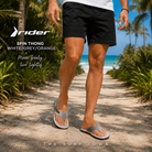 Chanclas Rider Spin Thong White Grey Orange en fotografía editorial propia de THE SURF TOWN en camino de arena blanca entre palmeras con estilo beach lifestyle masculino
