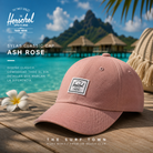 Gorra Herschel Sylas Classic Cap Ash Rose en fotografía editorial propia de THE SURF TOWN inspirada en un beach club premium de Bora Bora