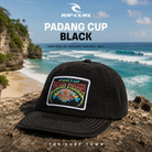 Gorra Rip Curl Padang Cup Black con fotografía editorial propia de THE SURF TOWN en Padang Padang Bali frente a las olas más famosas de Indonesia