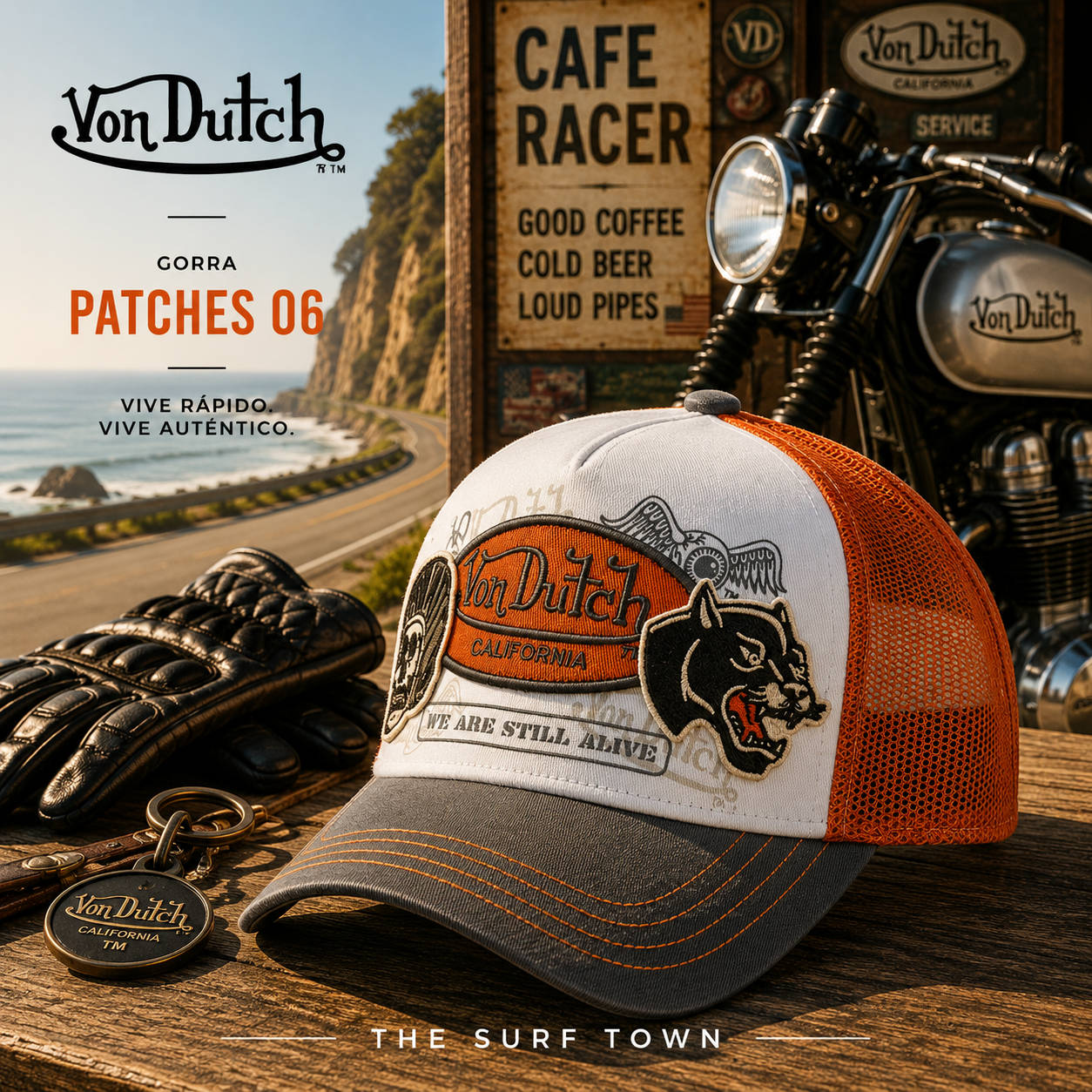 Gorra Von Dutch Patches 06 en fotografía editorial propia de THE SURF TOWN en ambiente cafe racer junto a moto clásica y carretera costera, gorra trucker vintage con parches bordados y estilo motero americano.