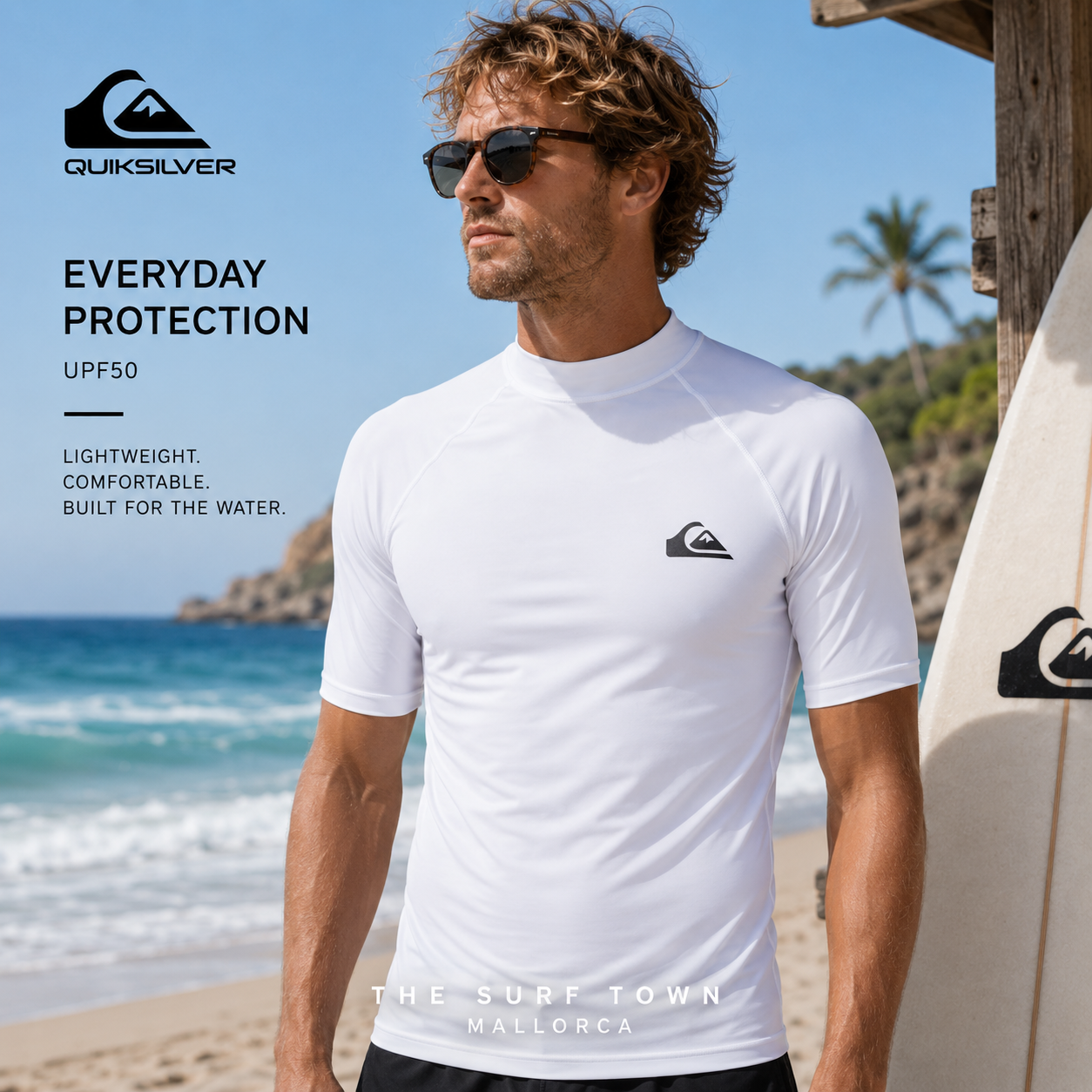 Licra Quiksilver Everyday UPF50 SS White en fotografía editorial propia de THE SURF TOWN junto al mar con tabla de surf y estilo surf performance premium bajo luz natural diurna