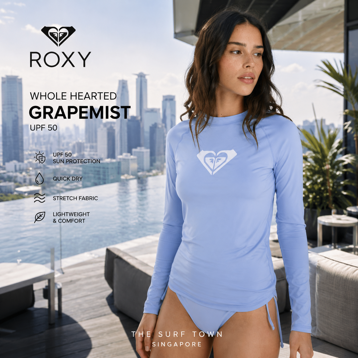 Fotografía propia de THE SURF TOWN de la licra Roxy Whole Hearted Grapemist para mujer en un rooftop de Singapur con skyline urbano premium y ambiente surf lifestyle contemporáneo.