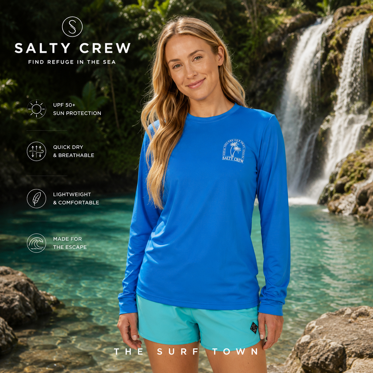 Licra Salty Crew Archway Sunshirt Bold Blue en cascada tropical exclusiva, fotografía editorial propia de THE SURF TOWN con modelo lifestyle femenino, protección solar UPF y estilo beachwear premium para actividades acuáticas