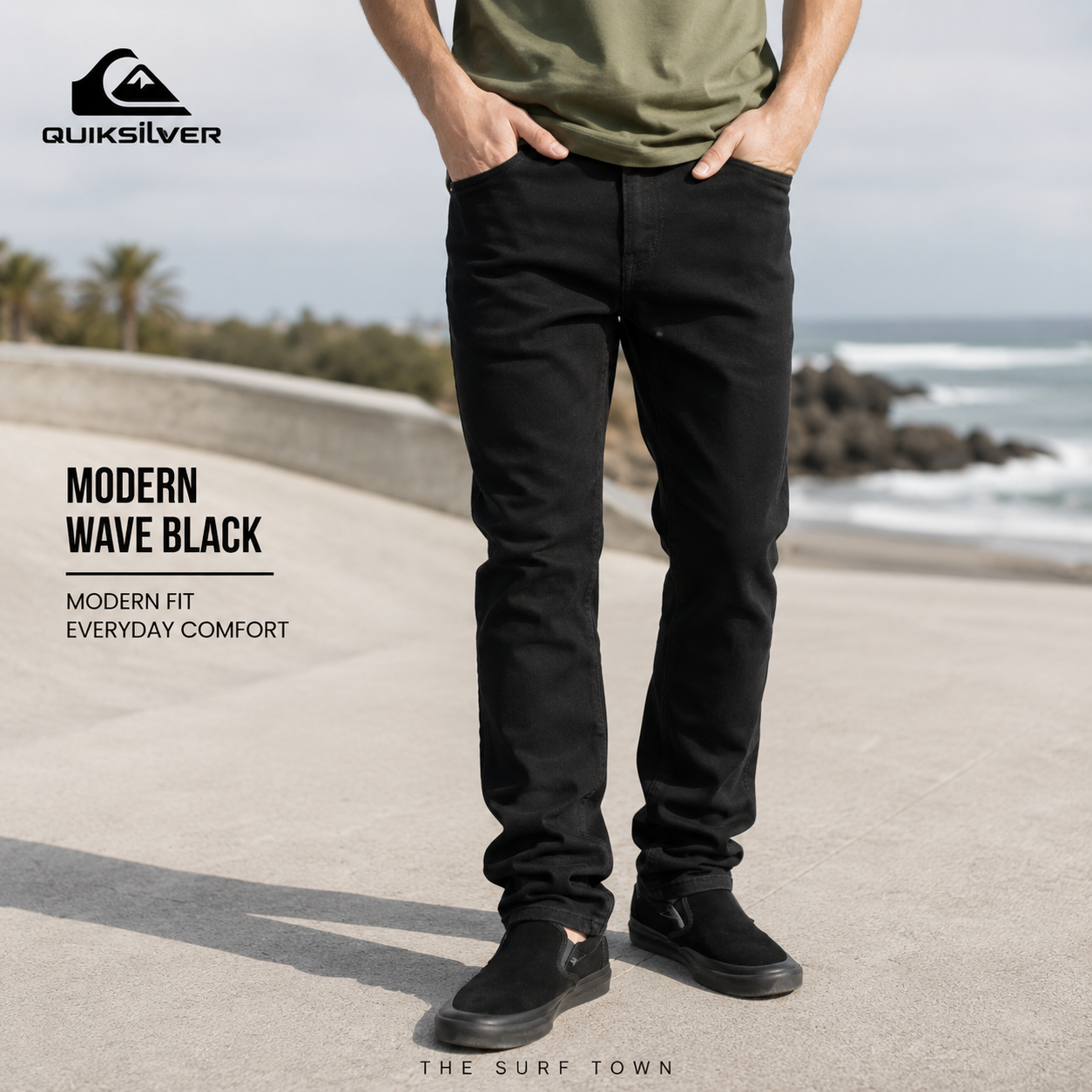 Pantalones Quiksilver Modern Wave Black en fotografía editorial propia de THE SURF TOWN, vaqueros negros para hombre con estilo surf urbano en paseo marítimo costero