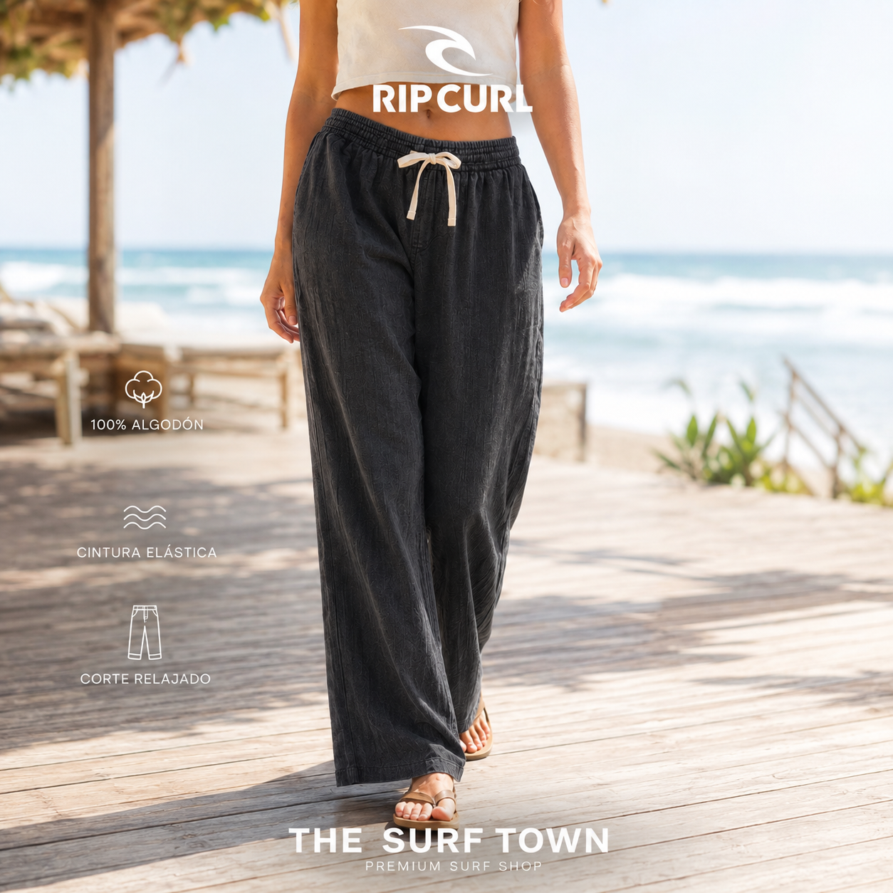 Pantalones Rip Curl AZ Classic Black para mujer en una escena vacacional junto al océano, imagen editorial propia de THE SURF TOWN