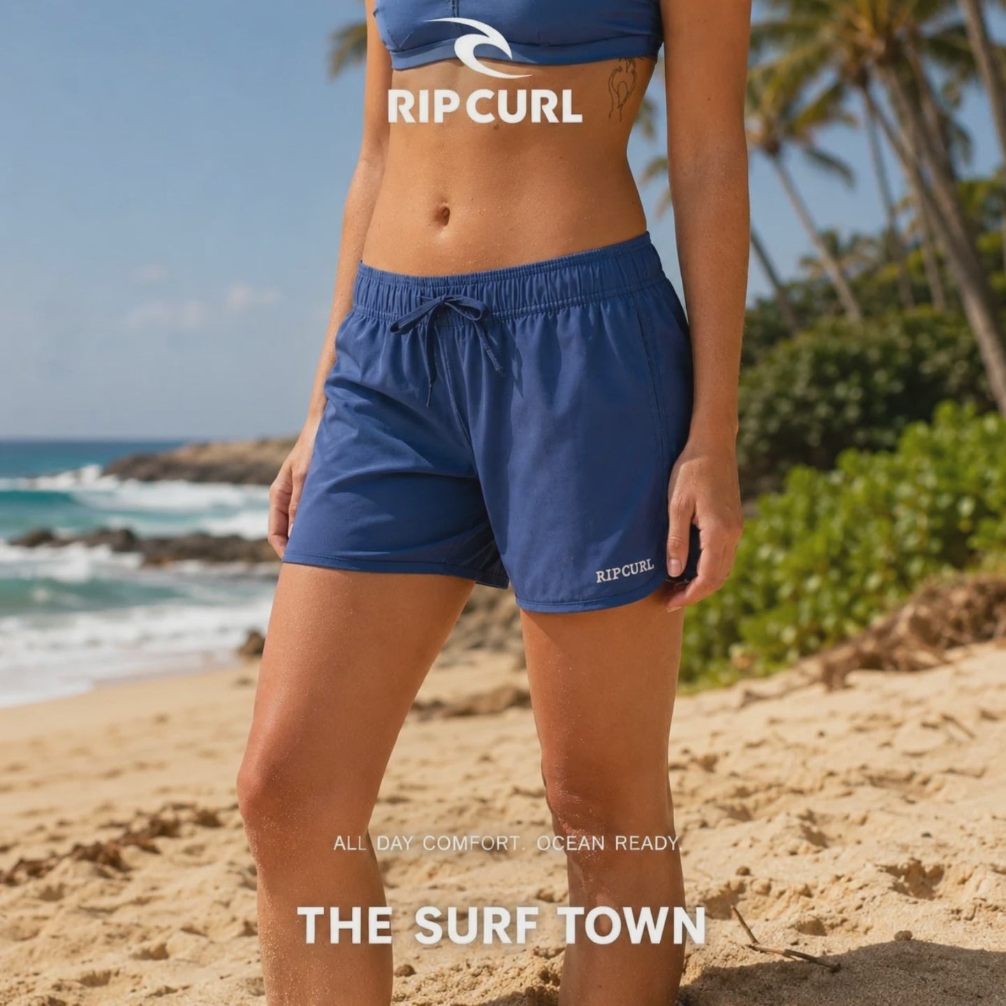 modelo vistiendo unos Pantalones Rip Curl Amazon 5in Surf Boarshort Navy durante una grabacion de video promocional propio de the surf town en una playa paradisiaca