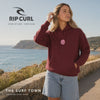 Video de Sudadera Rip Curl Icons of Surf Dark Plum para mujer con capucha y gráfico rosa, en un mirador frente al océano, video editorial propia de THE SURF TOWN.