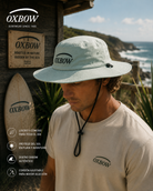 Sombrero Oxbow Ebush Eucalyptus verde con cordón en escenario coastal premium y estética editorial surf cinematográfica